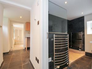 a kitchen with a glass wall in a room at Orchard Cottage in Saint Endellion +24 photos