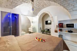 a room with a table with a bowl of fruit on it at Lanucara 5 in Martina Franca