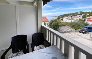 a balcony with two chairs and a table and a view at Beautiful Apartment In Duce With House Sea View in Duće