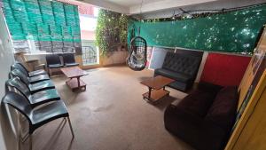 an overhead view of a waiting room with a couch and chairs at Eden Garden Homestay in Mysore