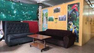 a living room with a couch and a table at Eden Garden Homestay in Mysore
