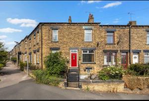 a brick house with a red door on a street at Summer Lane House-3 Bedrooms-Close to M1-Longer Stay-Free Parking in Barnsley