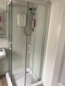 a shower with a glass door in a bathroom at Bantry Town in Bantry +15 photos