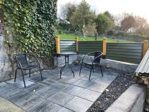 two chairs and a table on a patio at Bantry Town in Bantry