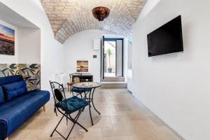 a living room with a blue couch and a table at Lanucara 6 in Martina Franca