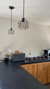 a kitchen with a stove top and a microwave at Cabaña en cafetales de Huatusco 