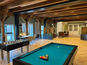 a pool table in a living room with a table at Schloms Hof in Waffensen