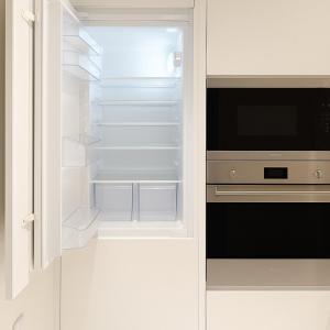 an empty refrigerator with its door open in a kitchen at 2 BR Soul Beach Mamsha Sadiyaat - Partial Sea view in Abu Dhabi