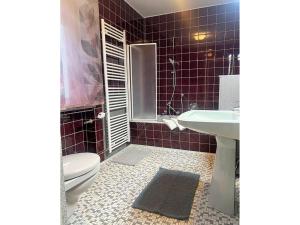 a bathroom with a toilet and a sink at Ferienwohnungen Erika Huber direkt an der Therme in Bad Birnbach +20 photos