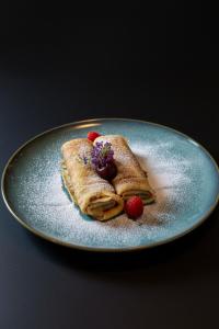 a plate with two waffles with berries on it at Prestige Yacht Resort Budapest in Budapest +38 photos