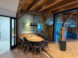 a dining room with a wooden table and chairs at Schloms Hof in Waffensen