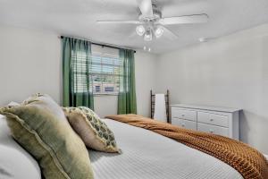 a bedroom with a bed and a ceiling fan at Gulf Haven in Anna Maria Island +45 photos