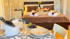 a table with a bowl of fruit and a bed at Suite Canal Salso by Ca-Sa Check in Mestre
