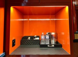 a drink dispenser with bottles of water on a shelf at Maison Muse Sablon in Brussels +18 photos