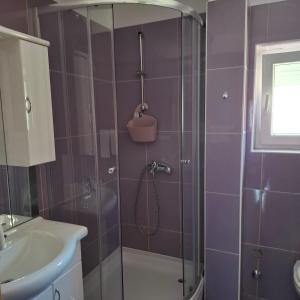 a purple bathroom with a shower and a sink at Jelly in Crikvenica +14 photos