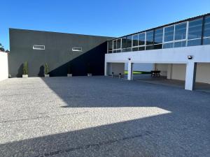 a building with a large parking lot in front of it at Lugar do Paraíso - duas casas, uma só experiência - Vila do Conde in Touguinho +5 photos