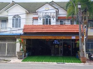 a building with a green mat in front of it at Hostel Luxury Sài Gòn in Rạch Giá