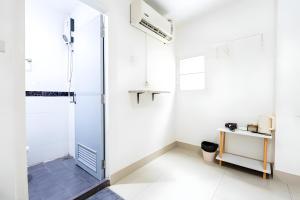 a shower stall in a bathroom with white walls at XX Oh My Naptel Nana Soi 3 -โอมาย แนปเทล ซอย 3 in Makkasan