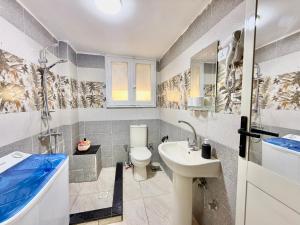 a bathroom with a toilet and a sink and a tub at Velvet Casa - Downtown Cairo in Cairo