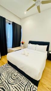 a large white bed in a room with a rug at Lucentia Residence Bukit Bintang By Panorama in Bukit Bintang +83 photos