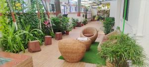 a room filled with lots of plants and furniture at DatsunG Studios Near Pune Airport in Pune
