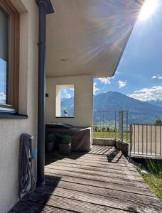 a porch with a deck with a view of a mountain at Apart Spieljochbahn in Fügenberg