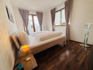 a bedroom with a large bed with a window at Apart Spieljochbahn in Fügenberg