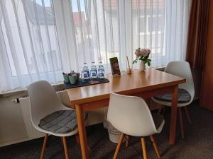 a wooden table with chairs and bottles of water on it at Zum Unstrut Radler in Helmsdorf