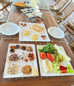 two white plates with different types of food on them on a table at ŞAH apart in Kemer