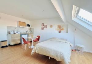 a bedroom with a bed and a table and chairs at Dreamz in Calais