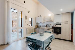 a kitchen with a table and some chairs and a table and a kitchen at Casa del Golfo in Castellammare del Golfo