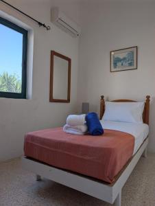 a bedroom with a bed and a window at Gozitan Charm in Xaghra with Pool in Xagħra +12 photos