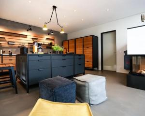 a large kitchen with a counter and a table at Nordic Bliss Cozy Villa with Jacuzzi & Sauna in Nørdstebø  +27 photos