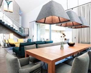 a living room with a wooden table and chairs at Nordic Bliss Cozy Villa with Jacuzzi & Sauna in Nørdstebø 