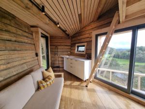 a living room with a couch and a large window at Backyard Camps in Bjerkreim