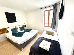 a bedroom with two beds and a window at Hotel Sennecey - Free Parking - BY PRIMO C0NCIERGERIE in Sennecey-le-Grand +38 photos