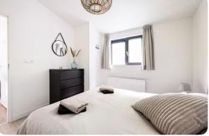 Un dormitorio blanco con una cama y un espejo. en De lodge met hottub, en Pingjum 33 fotos más