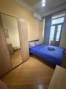 a small bedroom with a bed and a mirror at Republiq Square Buzand 7 street in Yerevan