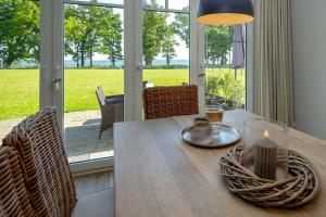 a dining room table with a candle on top of it at Reethus am Strand - Haushälfte 2 mit Kamin, Sauna in Lobbe