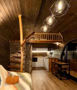 a room with a loft bed and a kitchen at Luxury Lodge with Hot Tub next to Belfry Golf Course 