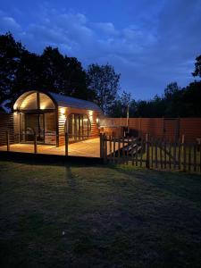 a gazebo in a field with a fence at Luxury Lodge with Hot Tub next to Belfry Golf Course  +15 photos