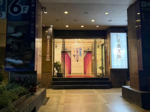 an entrance to a building with a red door at Xingyi Hotel in Chiayi City