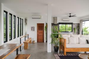 a living room with a couch and a table at Sunset villa rooftop with pool 180 Seaview in Koh Phangan