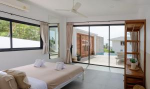 a bedroom with a bed and large windows at Sunset villa rooftop with pool 180 Seaview in Koh Phangan +35 photos