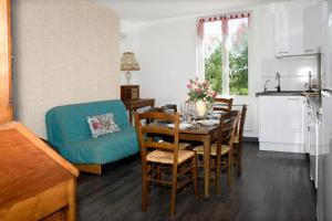 a kitchen and dining room with a table and chairs at Maison De Denise in Civray-de-Touraine