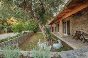a patio with a tree and a picnic table at Kompitsi View Retreat in Kompítsion