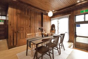a dining room with wooden walls and a table and chairs at 가나다스테이 GaNaDaStay ,Busan, Gwangalli-Beach #광안역 6번출구 8분거리#광안해수욕장 15분 #단체8인숙소 in Busan