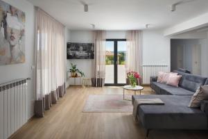 a living room with a couch and a table at Villa Roti by Rent Istria in Kostrčani