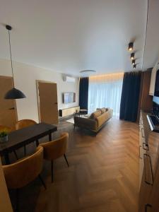a living room with a couch and a table at Two Bedroom Riverland Apartment in VNO +14 photos