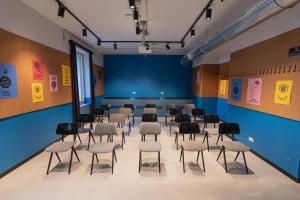 a conference room with chairs and a table in it at The Social Hub Florence Lavagnini Extended Stay in Florence +28 photos